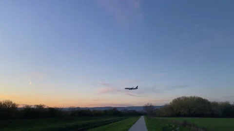Airplane taking off in the evening at sunset. The feeling of new journeys. Video stock 221195819