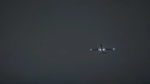Airplane taking off at night with landing lights Video stock 340476504