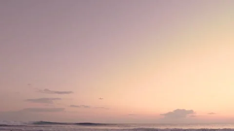 Airplane taking off over ocean at sunset Stock Footage 293082660