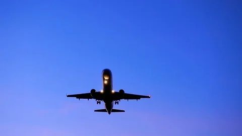 Airplane taking off over summer sky in sunset Stock Footage 96566593