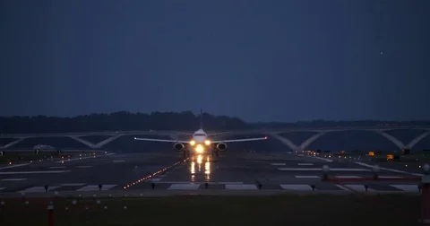 Airplane Taking off Reagan National Airport at Dusk Bright Lights Stock Footage 79946421