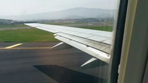 Airplane taking off from runway wing view (Jeju airport) Stock-Footage 333619096