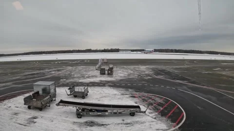 Airplane taking off from snow covered runway at Riga Airport in winter Stock-Footage 342533793