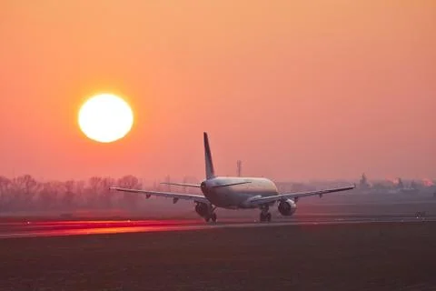 Airplane is taking off at the sunset. Stock-Fotos