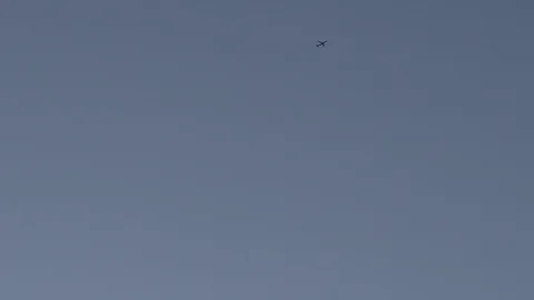 Airplane is taking off under head. Clear blue sky in the background Stock Footage 108884128