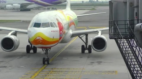 Airplane taxiing ends in the jetbridge Stock Footage
