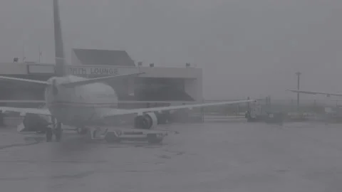 Airplane at the Terminal during a Storm Stock Footage 154005604