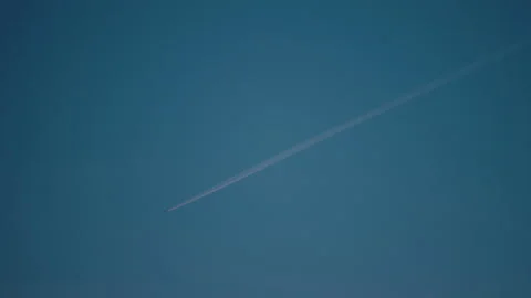 Airplane trail in the blue sky Stock Footage 229628942