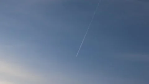 Airplane trail in blue sky Stock Footage 332902387