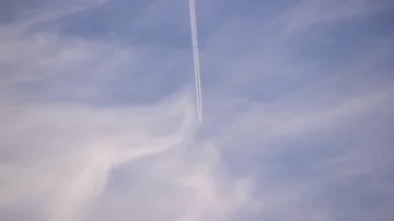 Airplane trail through bue sky medium shot Stock Footage 85607916