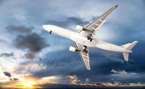 Airplane transportation. Jet air plane flies in blue sky Stock Photos