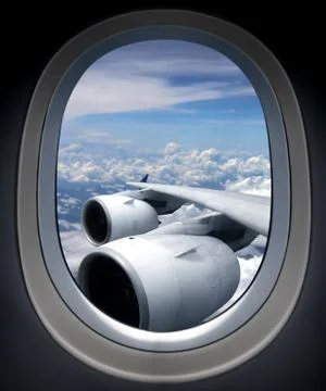 Airplane turbine engine from window view angle with cloudy blue sky Stock Photos