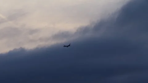 Airplane turning into dark clouds Stock Footage 270064153