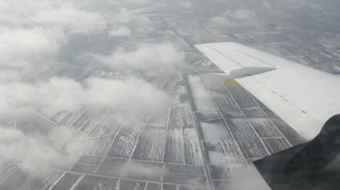 Airplane turning during approach in cloudy day Stockbeeldmateriaal 10790458
