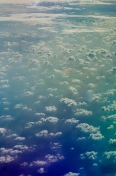 Airplane view to Altocumulus clouds and shadows of them above sea surface. Stock Photos