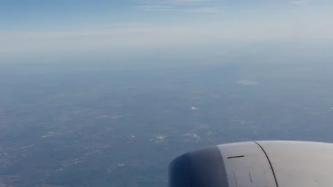Airplane view from window showing engine and landscape below during flight Stock Footage 335177534