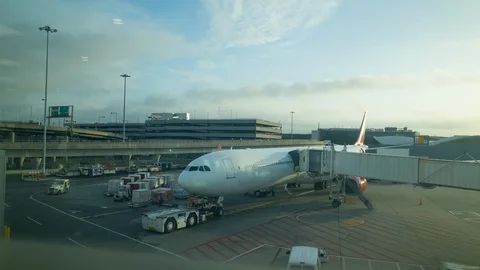 Airplane waiting at terminal gate, workers busy preparing for the next flight Stock Footage 95147408