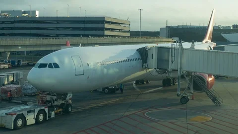 Airplane waiting at terminal gate, workers busy preparing for the next flight Stock Footage 95158701