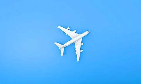 Airplane white model on the blue background for the concept of online tickets Stock Photos