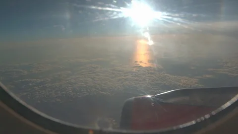 Airplane Window Bright Sunset Over Atlantic Handheld, 4K Stock Footage 126927557