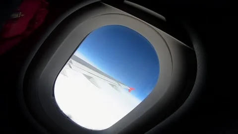 Airplane window (cinematic camera movement) Blue sky air wing Stock Footage 143525587