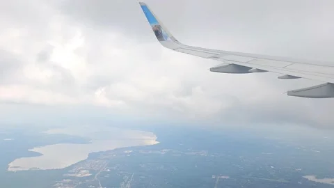 Airplane Window Cloudy View Arriving at Orlando Airport Timelapse Stock Footage 240021688