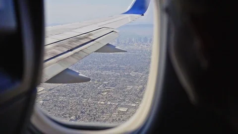 Airplane Window Downtown Los Angeles Boy Looks Out Landing LAX Stock Footage