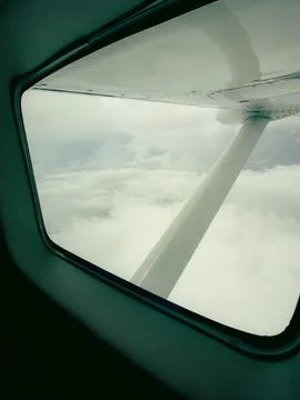 Airplane window frame borders a serene sky view Stock Photos