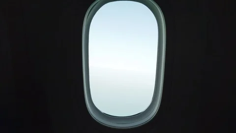 Airplane window looking down to the land from an airplane window Stock Footage 117073374
