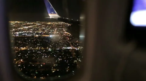 Airplane Window Seat - View of Los Angeles at Night and Wing of Plane on Flight Stock Footage