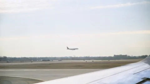 Airplane window seat view of plane landing on airport runway (slow motion) Stock Footage 109074064