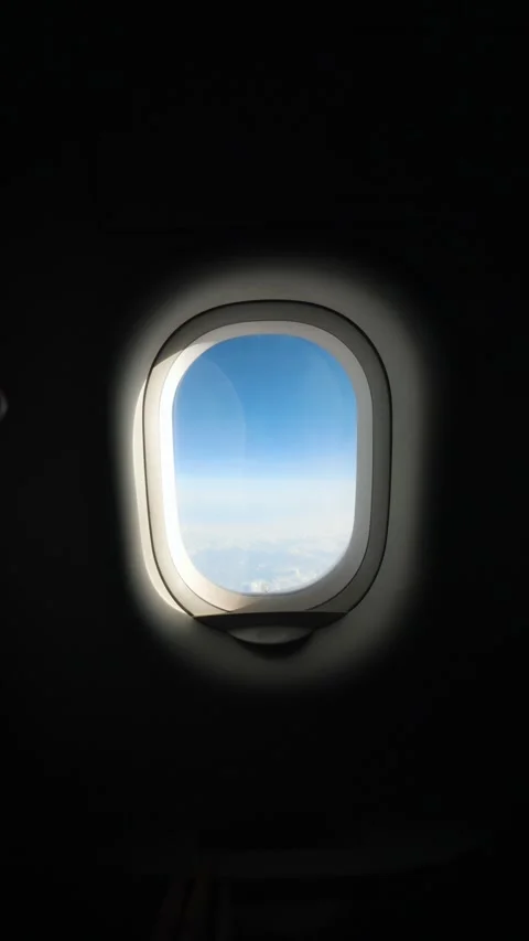 Airplane Window Shade Opening to Reveal Stunning View of Sky and Wing, Scenic Stock Footage 294743628