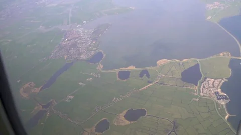 Airplane window shot, amazing view of sea and town from plane, travel by air Video stock 79882889