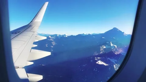 Airplane window with sky clouds and mountains Stock Footage 247159990