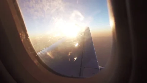 Airplane window sunflare transition sunset Stock Footage 123364496