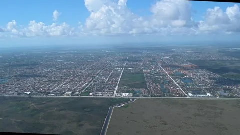 Airplane Window View: 4K Flight Approach Over the Florida Everglades and Miami Stock Footage 341001878