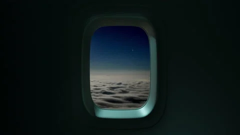 Airplane Window View Above the Clouds at Sunset Stock Footage 137513087
