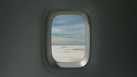 Airplane Window View Above the Clouds at Sunset Stock Footage 137513496