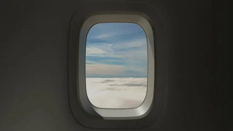 Airplane Window View Above the Clouds at Sunset Stock Footage 137514557