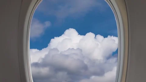 Airplane Window View Above the Clouds. Close up of a Airplanes Window. Stock Footage 228949487