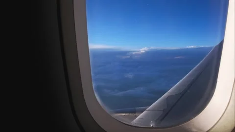 Airplane Window View Above the Clouds at Sunset Stock Footage 308810555