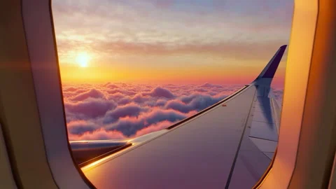 Airplane Window View Above the Clouds at Sunset. Beautiful purple and orange sky Stock Footage 313150280