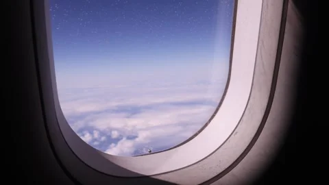 Airplane Window View Above Clouds in Sky Stock Footage 345780740