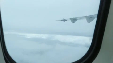 Airplane Window View Above the Cloudy sky Stock Footage 274460949