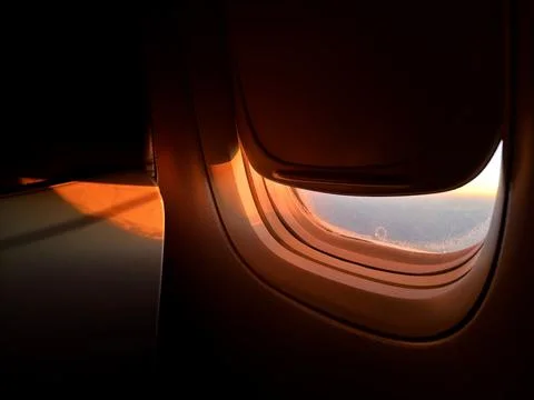Airplane window with view of blue clouds and frozen water particles on the Foto stock