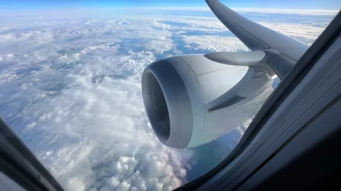 Airplane Window View With Blue Sky And Fluffy Clouds At Sunset Video stock 319959057