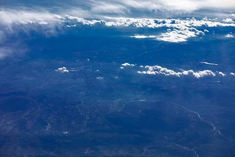 Airplane window view clouds stretching across earth Fotos Stock
