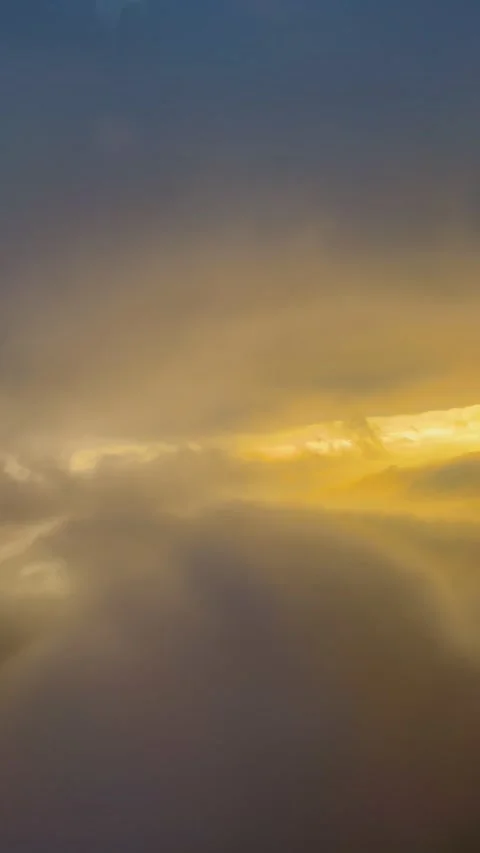Airplane window view of descent through clouds at sunrise with diffused light Stock Footage 344412725