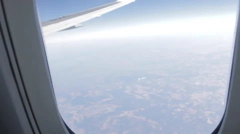 Airplane Window View of Earth and Wing , Zoom Out, Flying Stock Footage 47578326