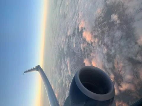 Airplane window view with engine and snow covered mountains Stock Photos
